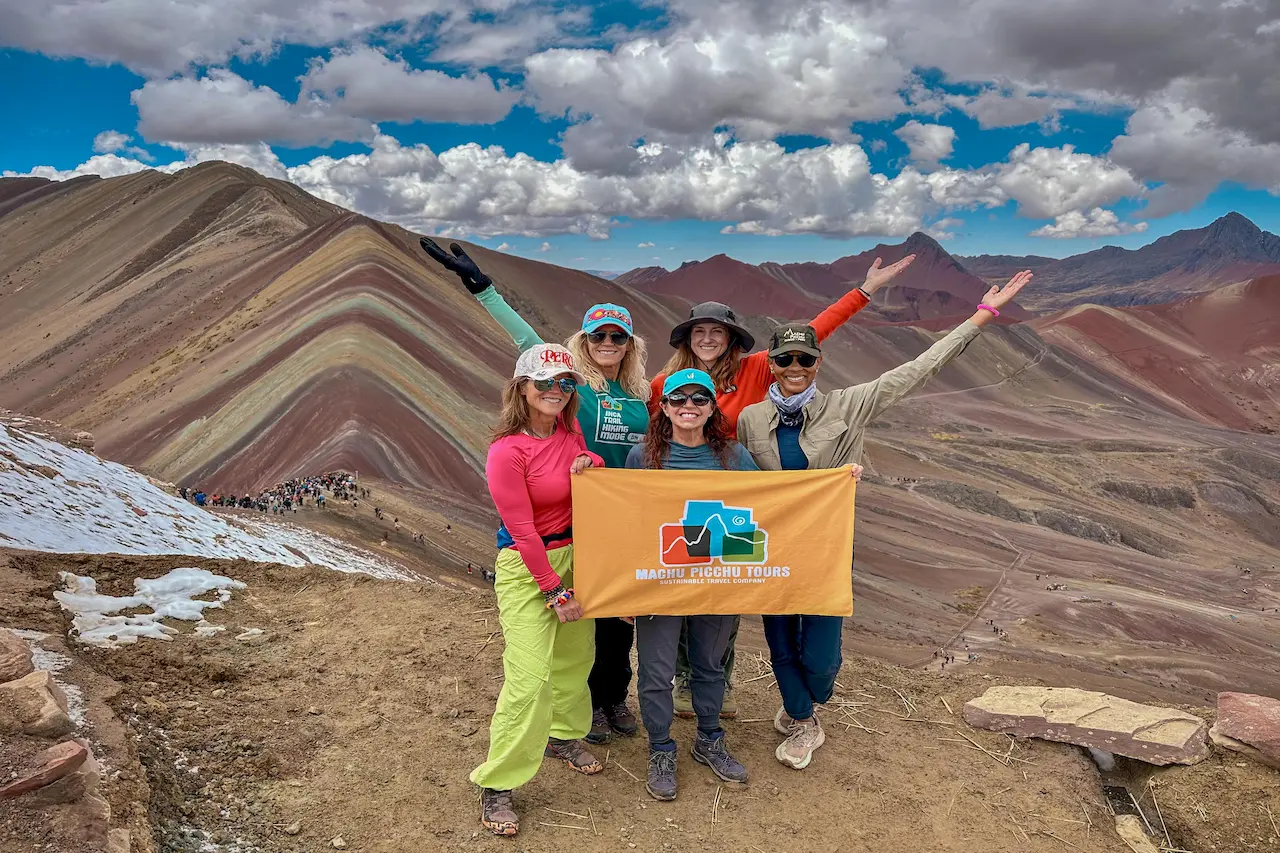 Traveler admiring the view from Vinicunca Rainbow Mountain viewpoint